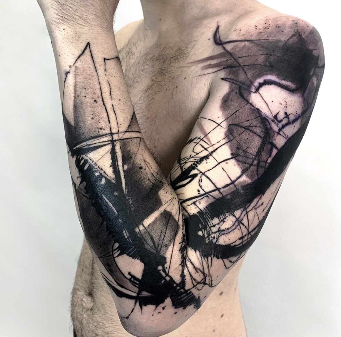 Abstract tattoo on back with geometric and organic shapes, demonstrating Natalie Nox's versatility