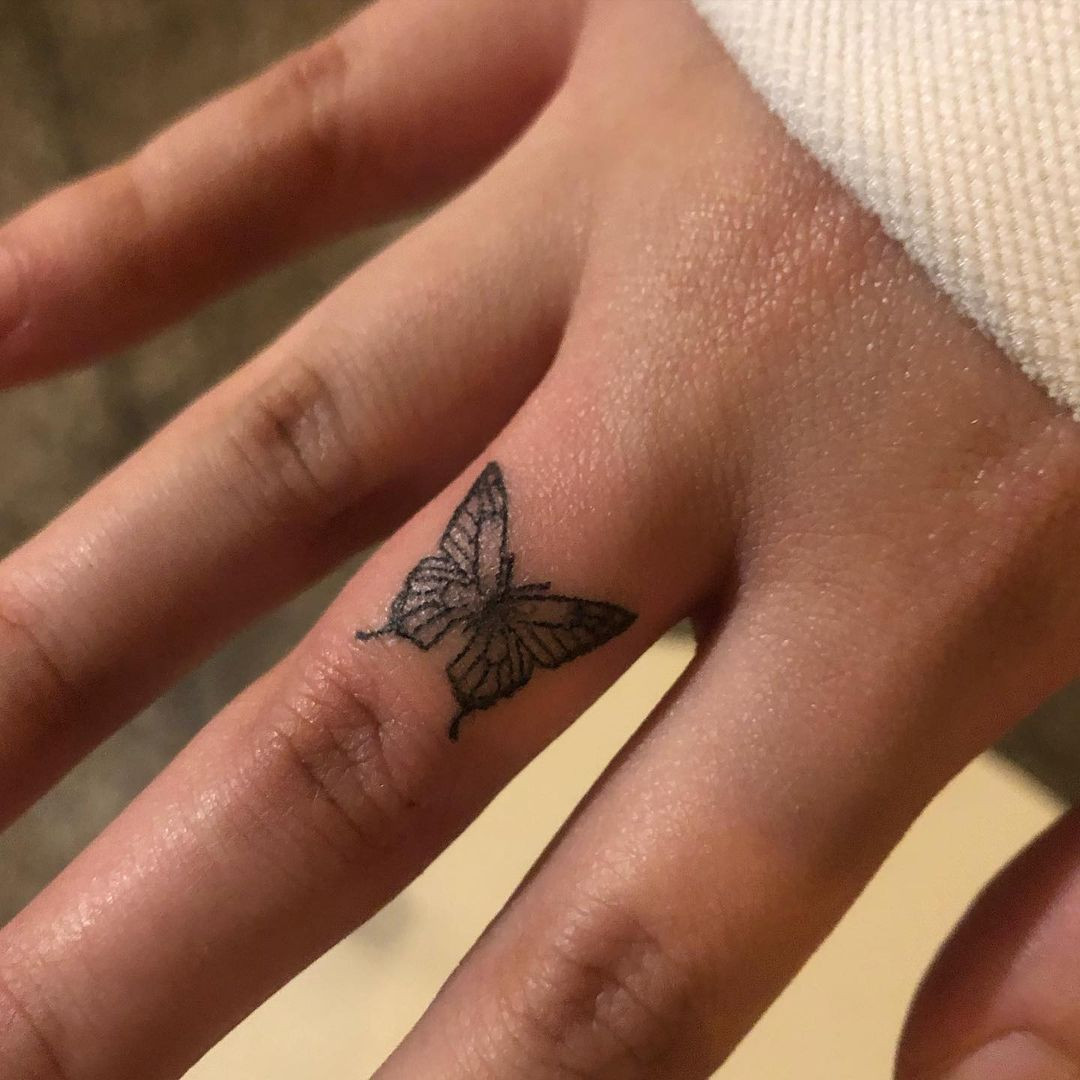 Butterfly finger tattoo in a simple style