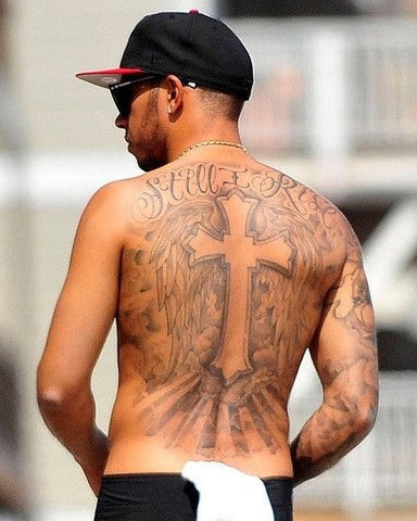 Cross tattoo on a man's back, centrally placed as a symbol of faith