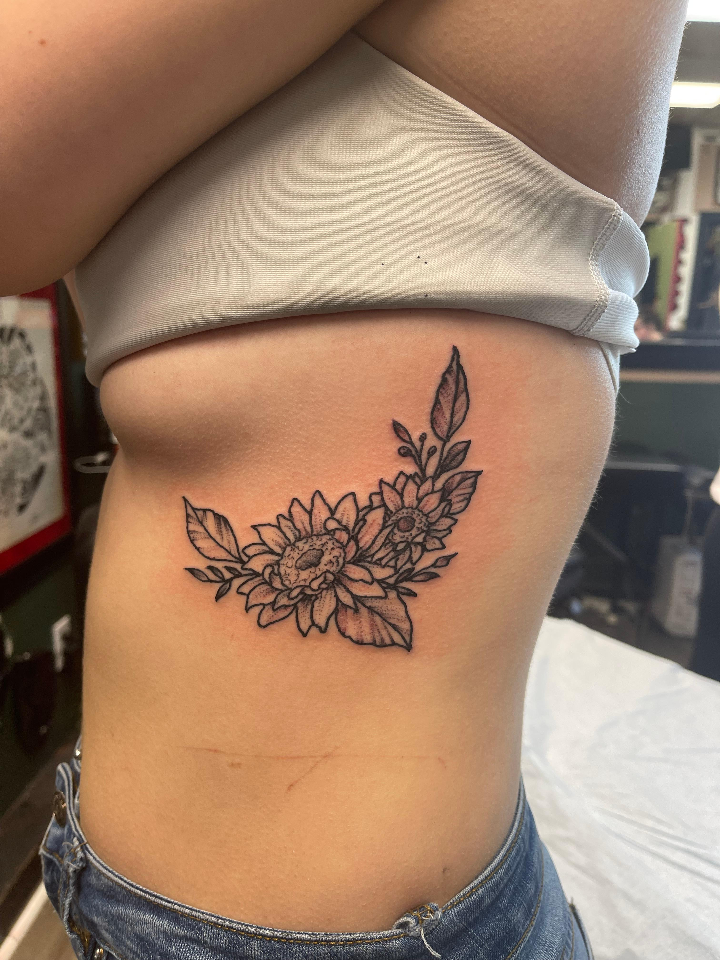 Floral tattoo on ribs for women