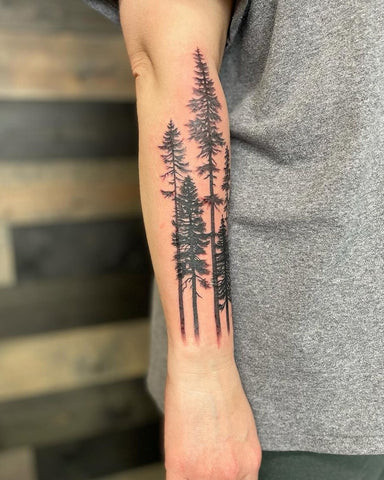 Forearm tree tattoo drawing with detailed branches and leaves symbolizing growth and nature.