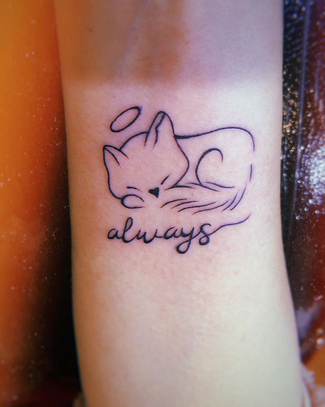 Unique cat tattoo for women, playful pose and minimalist style for cat lovers