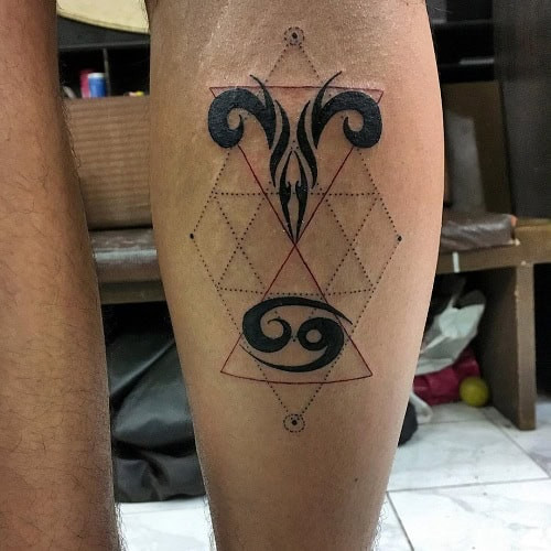 Taurus and Cancer zodiac symbols intertwined in a tattoo on the arm