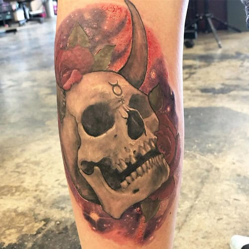 Black and grey ink Taurus bull skull tattoo on the thigh