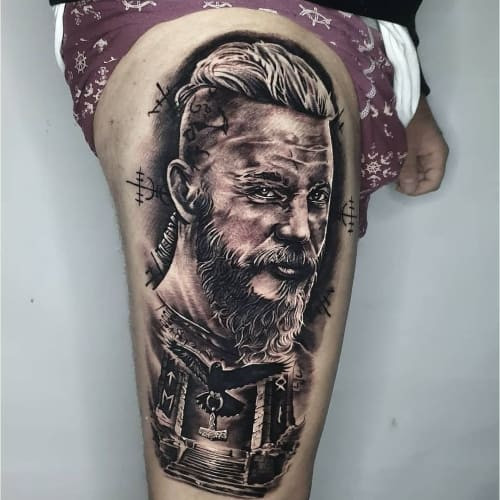 Thigh tattoo with a compass and map, a detailed and adventurous placement for men.