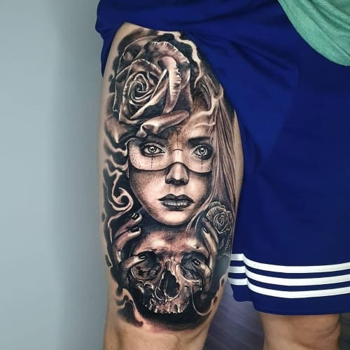 A thigh tattoo with a side placement on a man's outer thigh, detailed artwork