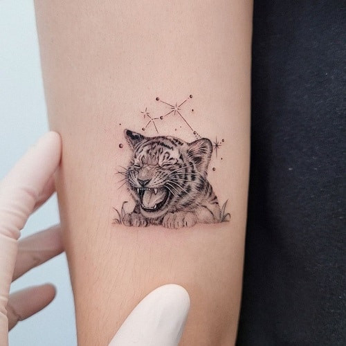 Tender tiger cub tattoo symbolizing rebirth and new beginnings