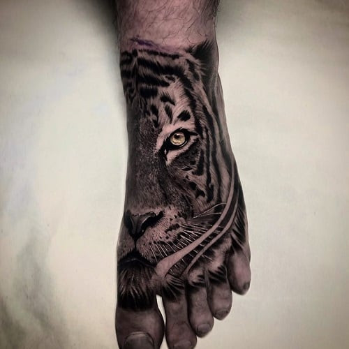 Discreet tiger foot tattoo for a hidden symbol of strength