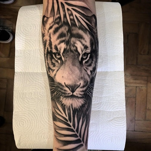 Popular tiger forearm tattoo for visible strength statement