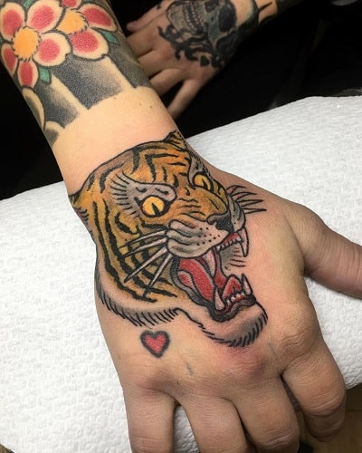 Bold tiger hand tattoo for open display of fierceness