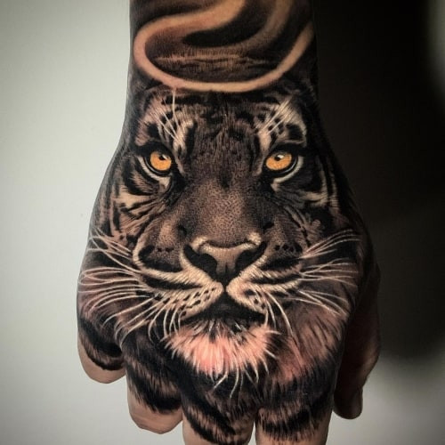 Japanese style tiger tattoo covering the arm, showcasing intricate and powerful men tattoo ideas.