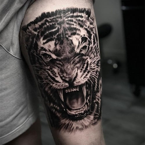 Impactful tiger thigh tattoo for bold and detailed art