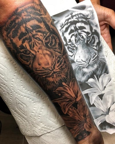 Nature-connected tiger with lily tattoo enhancing natural beauty