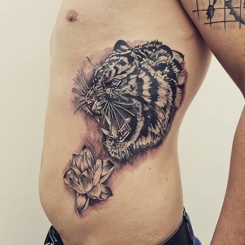 Resilient tiger with lotus tattoo symbolizing overcoming adversity