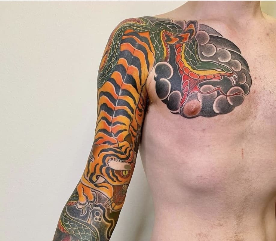 Introspective tiger and snake tattoo depicting inner conflict