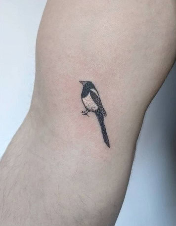 Minimalist tiny bird tattoo for men on the finger, a delicate and hidden symbol