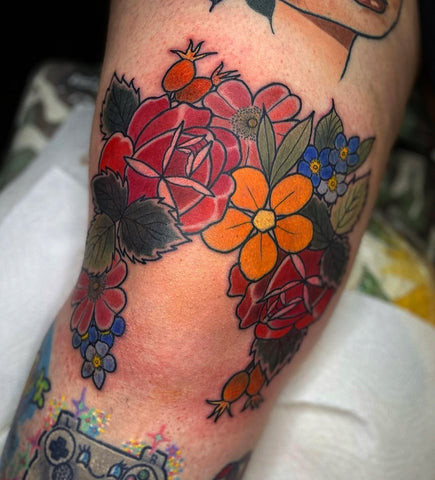 Above the knee floral tattoo by Hanah Elizabeth