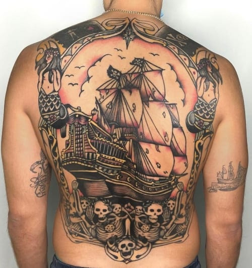 Two traditional tattoos on men, one on the chest with a stylized traditional heart and banner and another on the shoulder with a geometric traditional pattern.