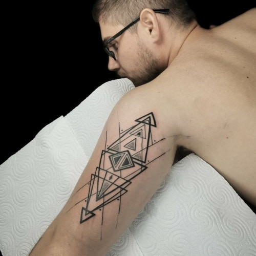 Triangle geometric tattoo featuring a triangle or a pattern of triangles with geometric precision, representing balance and trinity.