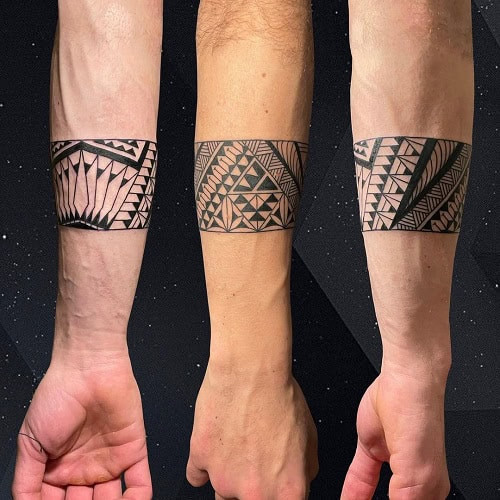 Tribal armband tattoo on a man's arm, featuring a circular armband design with tribal patterns.