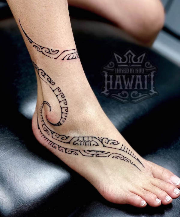 Tribal foot tattoo for women, blending traditional tribal patterns with feminine cursive shapes, celebrating heritage