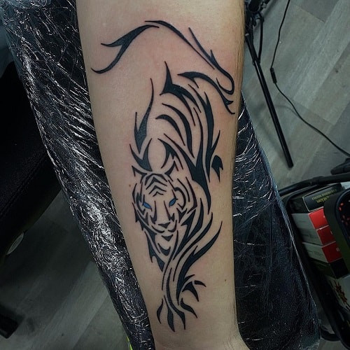 Strong tribal tiger tattoo with bold black lines