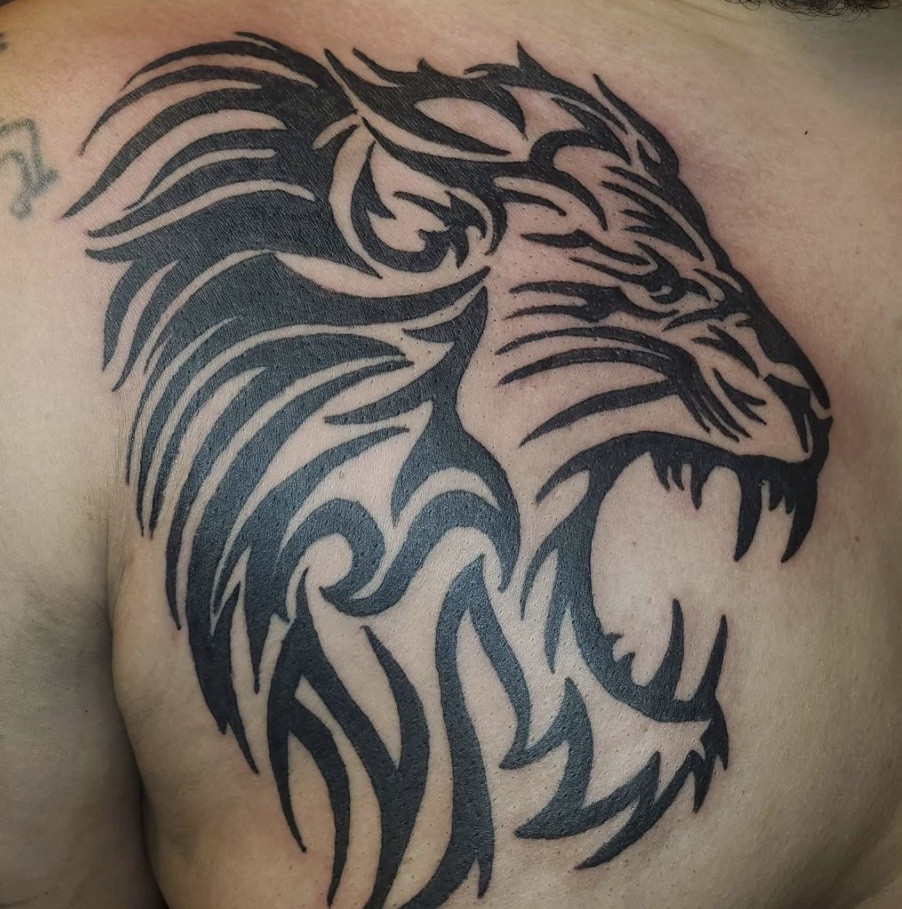 Tribal Lion Tattoo, bold black lines, geometric tribal patterns