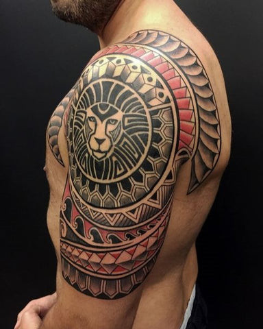 A Maori tribal tattoo design extending across a man's shoulder and upper arm