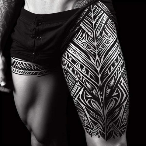 Intricate tribal pattern thigh tattoo for men.