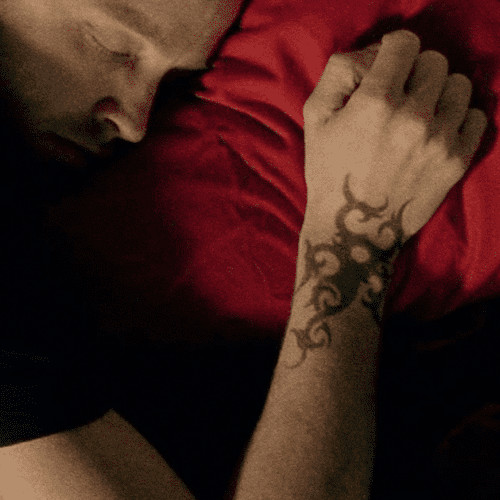 Jesse Pinkman iconic pose, showcasing tattoos