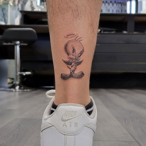Playful Tweety Bird tattoo for men, a nostalgic symbol of childhood innocence and luck