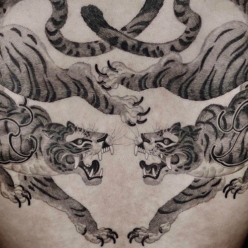 Bold twin tiger tattoo amplifying protection and strength