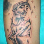 Unconventional Tupac tattoo art: A humorous depiction of Tupac Shakur as a unicorn, complete with pixie dust and blood droplets. This unique tattoo design showcases the wide range of creative and sometimes bizarre Tupac tattoo ideas.