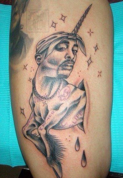 Unconventional Tupac tattoo art: A humorous depiction of Tupac Shakur as a unicorn, complete with pixie dust and blood droplets. This unique tattoo design showcases the wide range of creative and sometimes bizarre Tupac tattoo ideas.