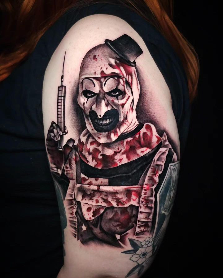 Black and grey horror realism tattoo with red accents by Marissa Gray.