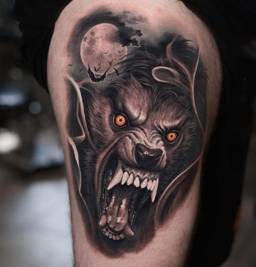 A werewolf tattoo on a man's arm, depicting a transforming werewolf figure, symbolizing inner demons, hidden qualities, and the transformative aspects of the self.