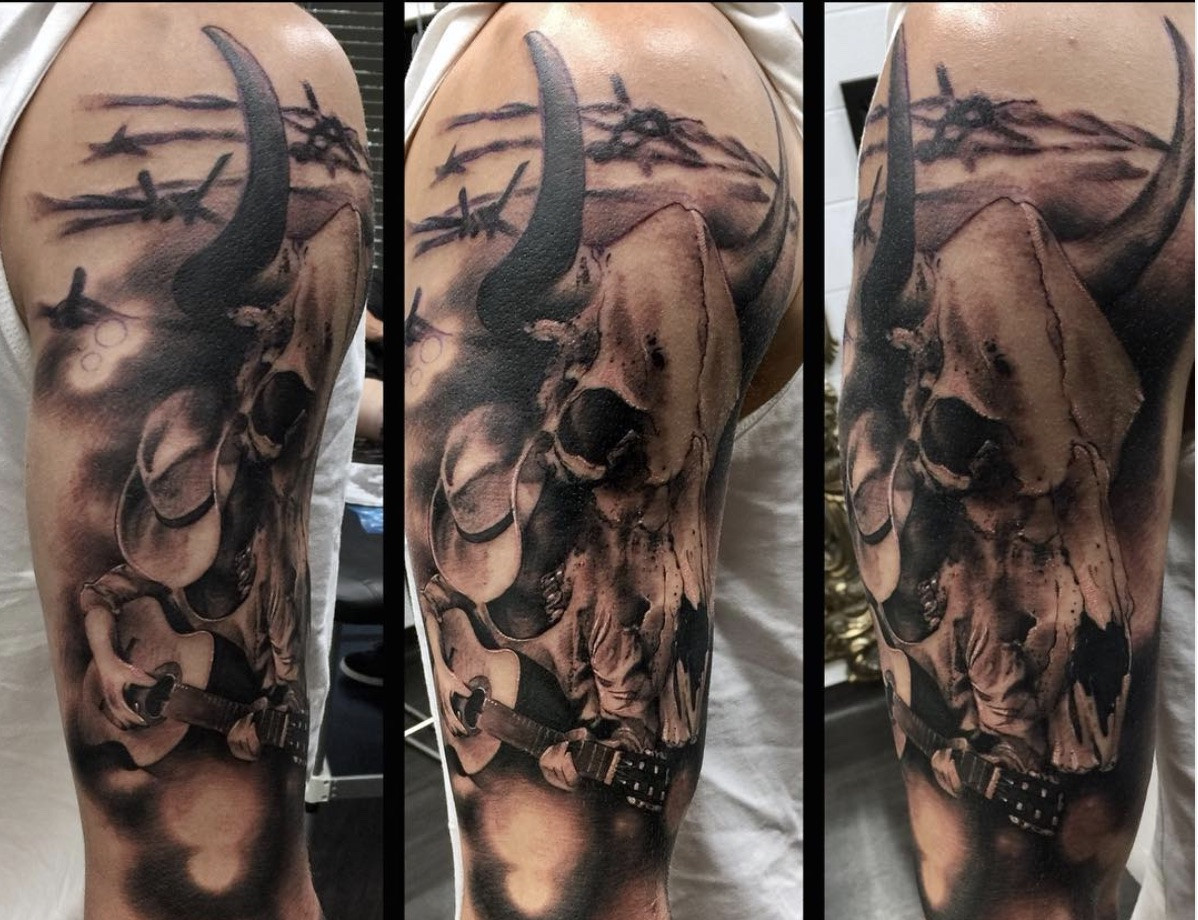 Full cowboy sleeve tattoo with western scenes and characters