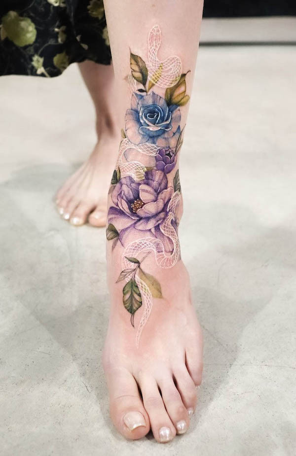 White snake and flowers foot tattoo, featuring a hidden white snake subtly revealed amongst the floral design, adding mystery