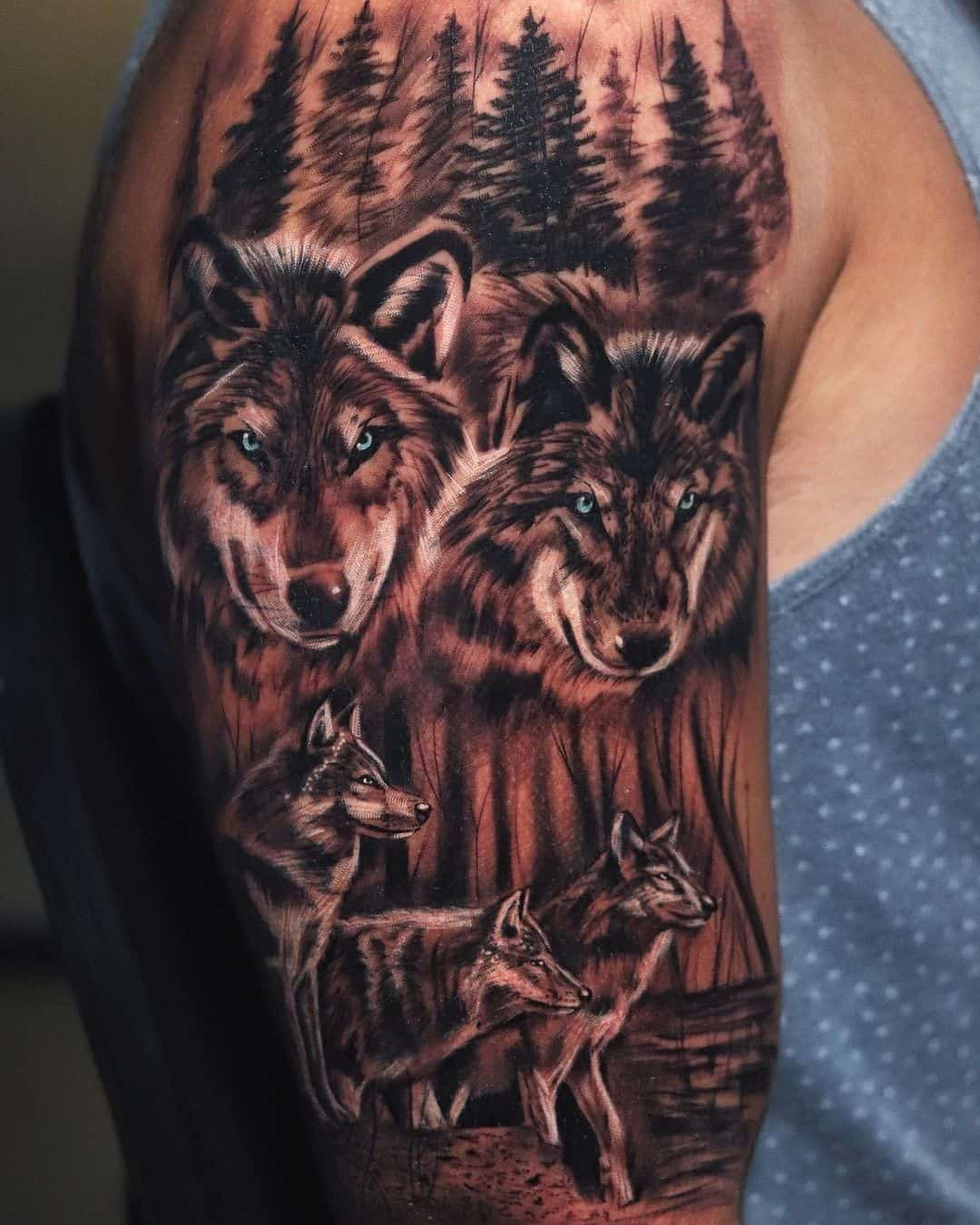 A wolf pack tattoo on a man's back, depicting multiple wolves in a dynamic group, symbolizing loyalty, unity, and the importance of family bonds.