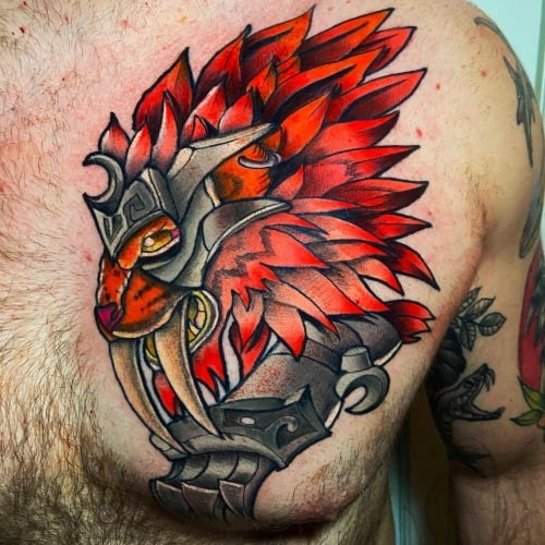 A World of Warcraft faction symbol tattoo on a man's shoulder, subtle game tribute