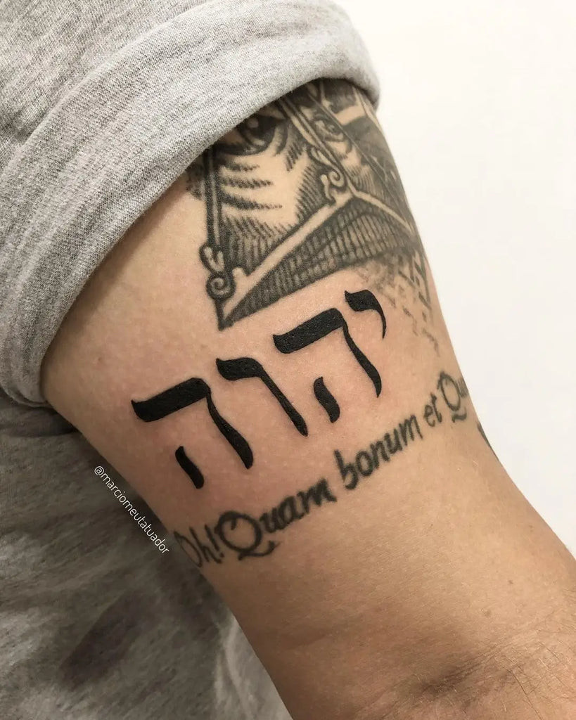 Yahweh Tattoo on the shoulder with a stylized Hebrew script integrated into a geometric shape