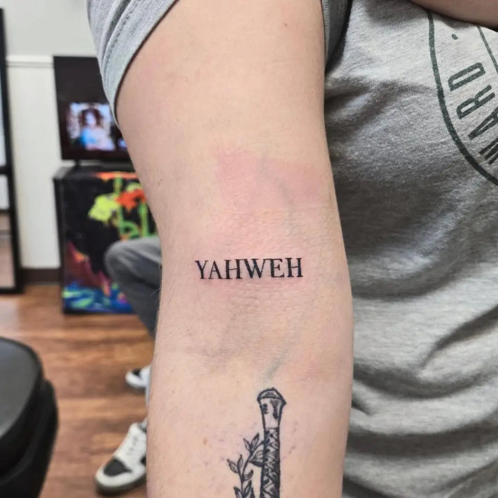 Yahweh Tattoo featuring different names of God in Hebrew script on the arm