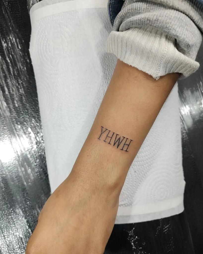 Yahweh Tattoo on the ankle with a simple yet impactful Hebrew script band