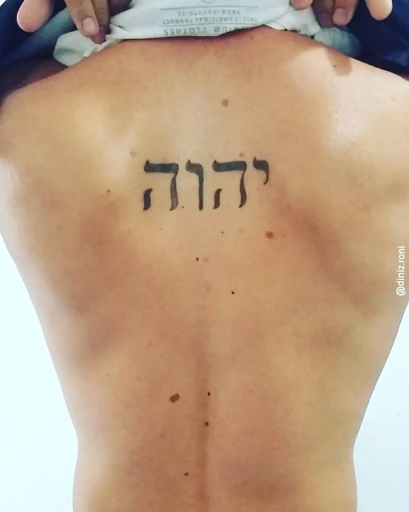 Yahweh Tattoo on the forearm with a shaded Hebrew script and geometric patterns