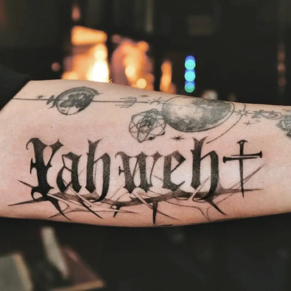 Yahweh Tattoo on the hand with Hebrew script lettering across the knuckles