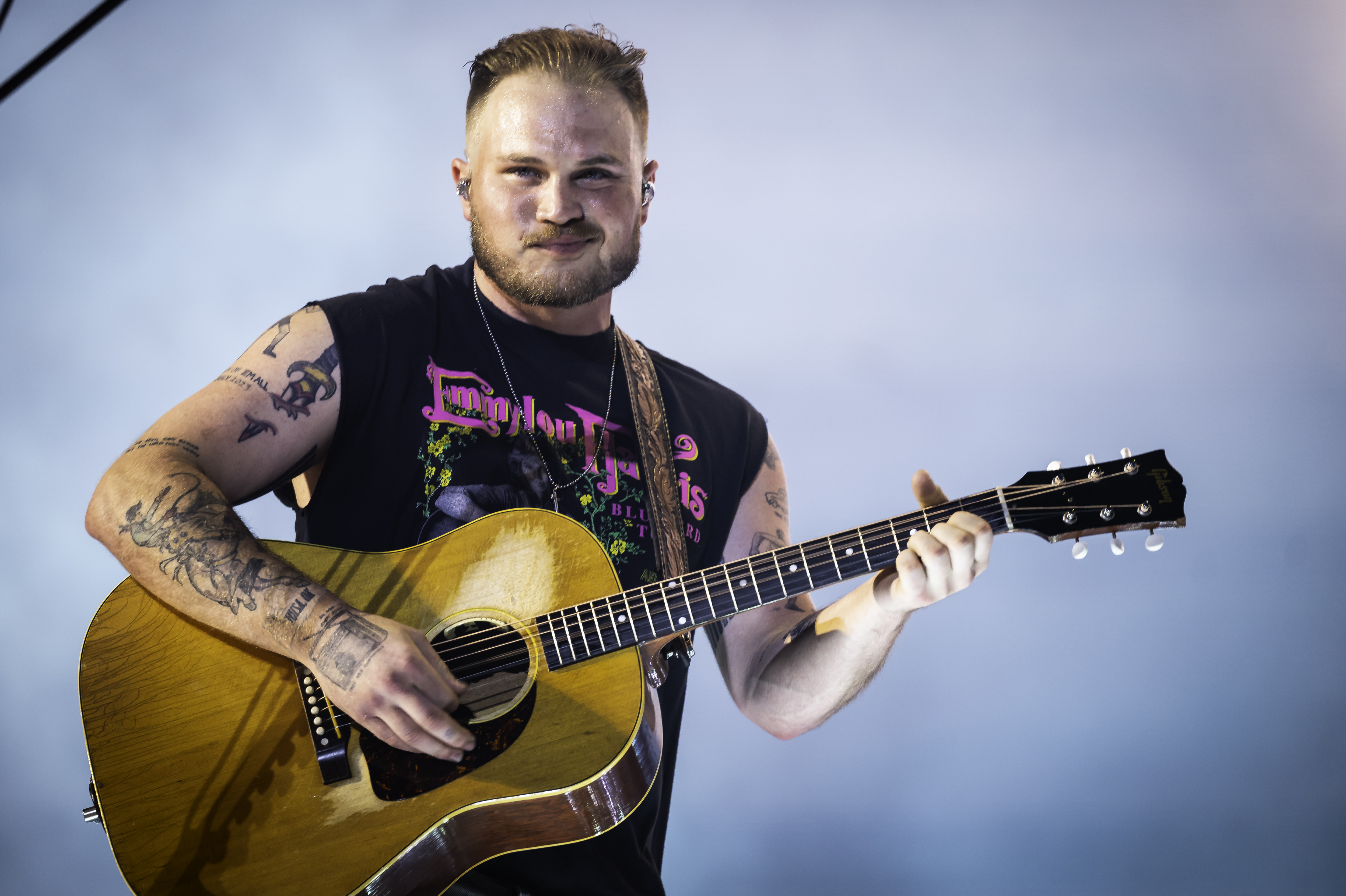 Zach Bryan performing on stage