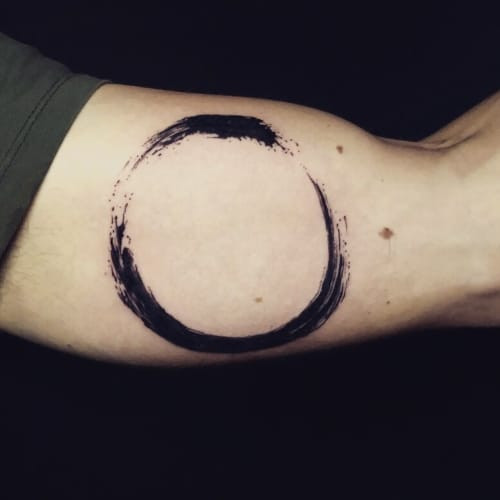 Enzo circle tattoo on the shoulder, representing zen in men tattoo ideas.