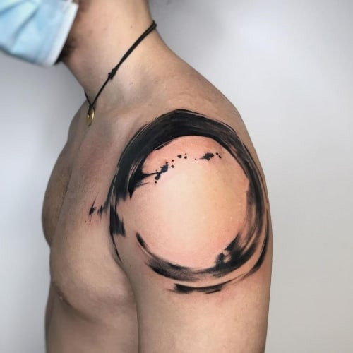 A minimalist Zen Enso circle outline tattoo on a man's wrist, subtle spiritual symbol