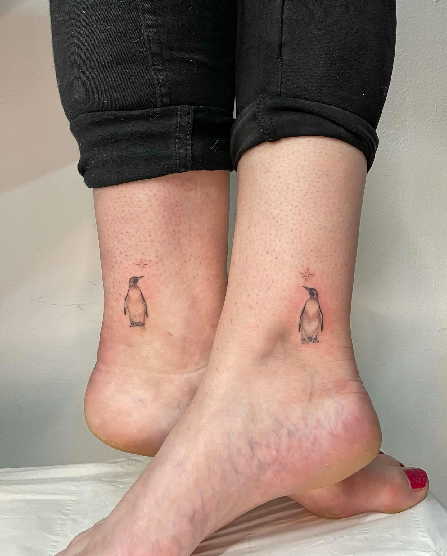 Penguin ankle tattoo, cute penguin design on woman's ankle.