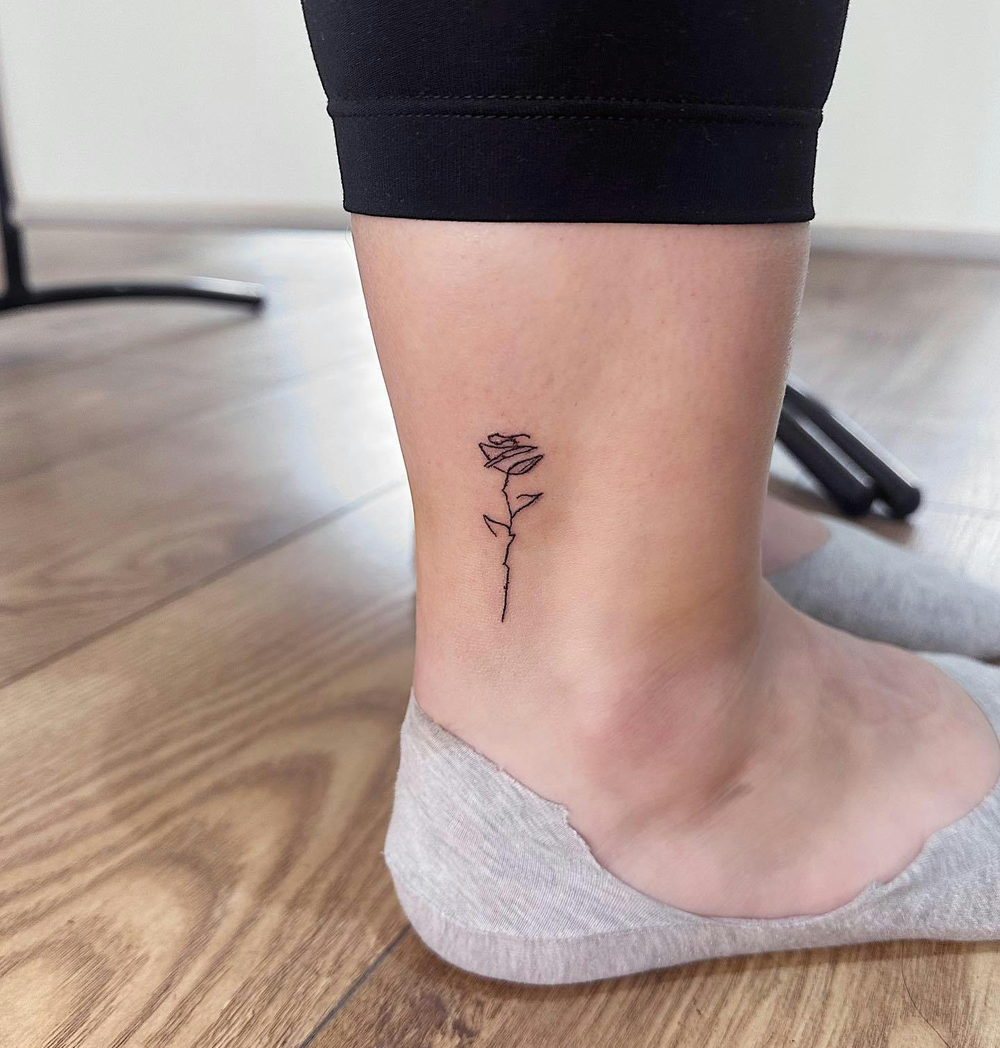 Rose ankle tattoo for women, delicate floral design.